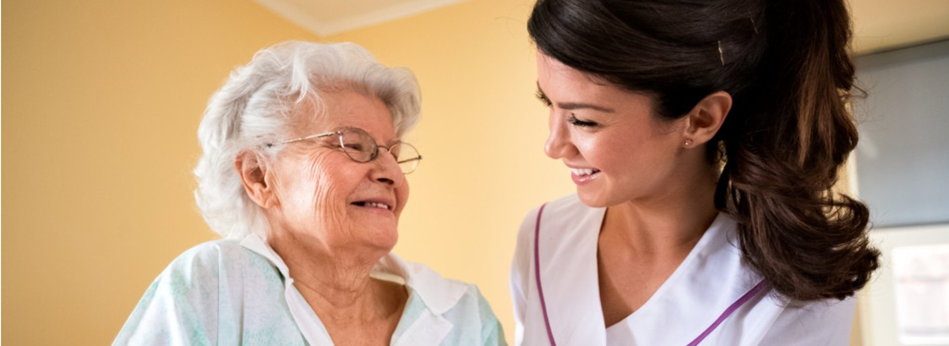 caregiver smiling with senior citizen part 3