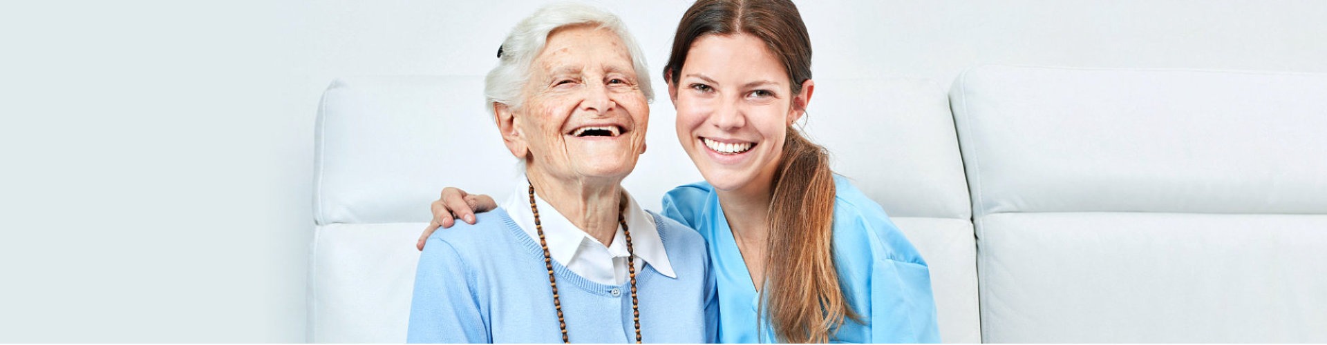 caregiver and old lady smiling