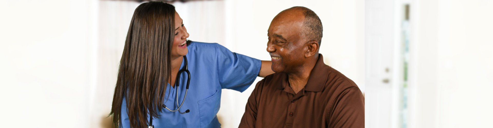 female nurse and senior man smiling